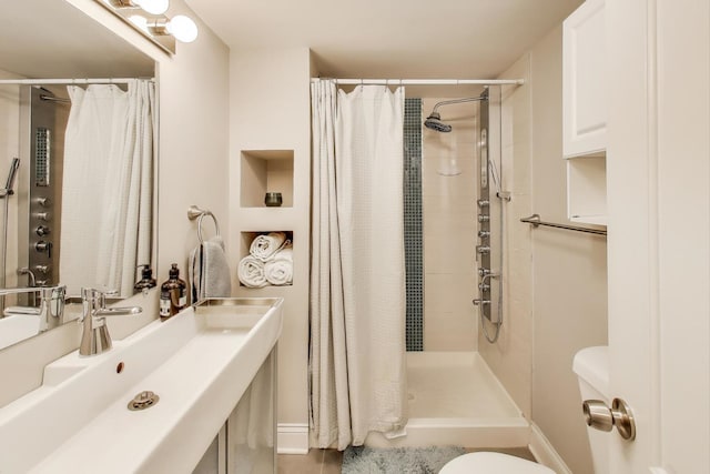full bath with a tile shower and a sink