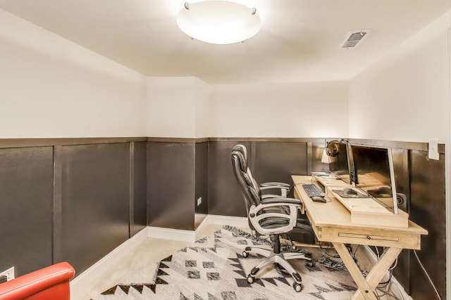 office area featuring visible vents and carpet flooring
