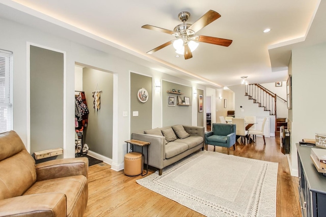 living room with baseboards, recessed lighting, wood finished floors, a ceiling fan, and stairs