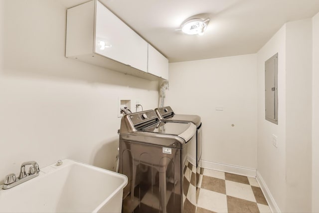 washroom with independent washer and dryer, a sink, electric panel, cabinet space, and light floors