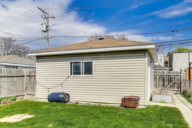 view of home's exterior featuring a lawn and a fenced backyard
