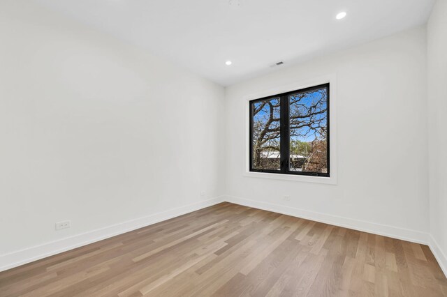 unfurnished room featuring recessed lighting, baseboards, visible vents, and light wood-style flooring