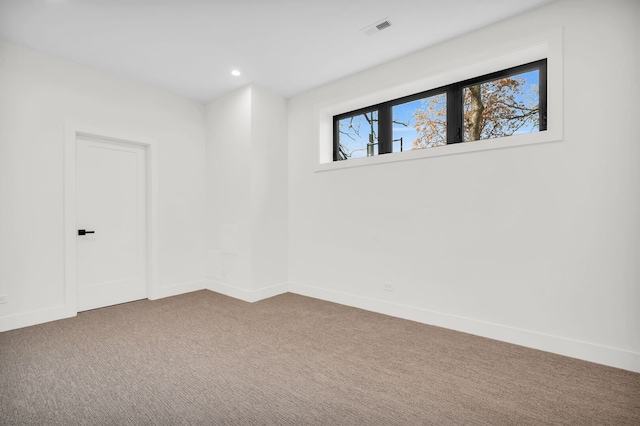 carpeted spare room with visible vents, recessed lighting, and baseboards