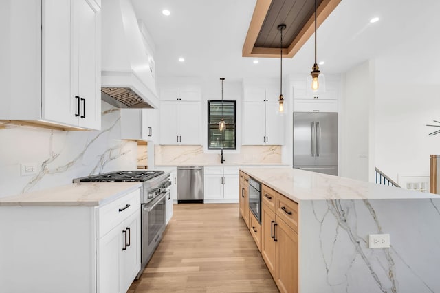 kitchen featuring decorative backsplash, high quality appliances, premium range hood, light wood finished floors, and recessed lighting