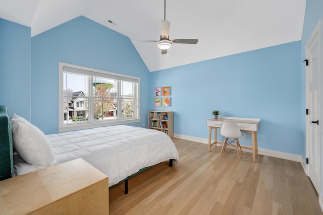 bedroom featuring vaulted ceiling, wood finished floors, baseboards, and ceiling fan