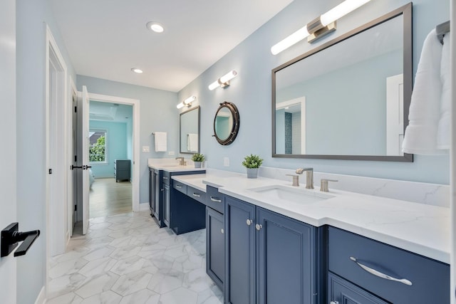 full bath featuring vanity, recessed lighting, marble look tile flooring, and baseboards
