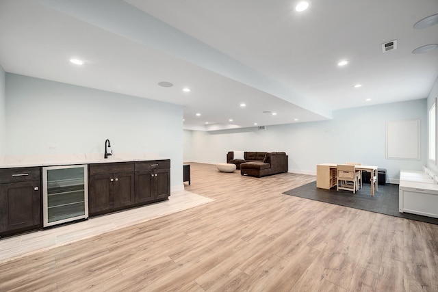 indoor wet bar featuring wine cooler, light wood-style floors, baseboards, and recessed lighting