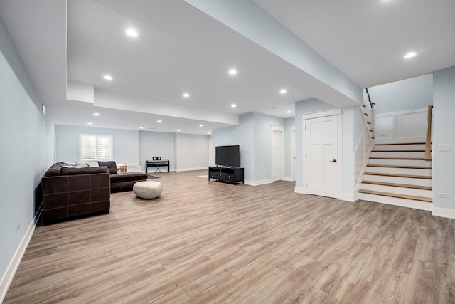 living area featuring stairs, wood finished floors, baseboards, and recessed lighting