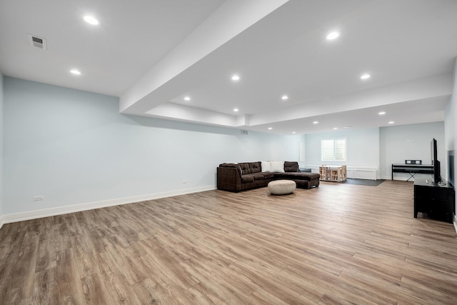 living area with wood finished floors, baseboards, and recessed lighting
