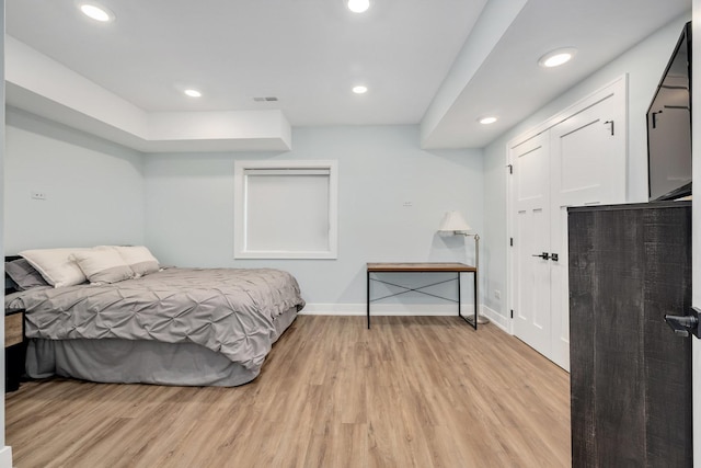 bedroom with light wood finished floors, baseboards, and recessed lighting