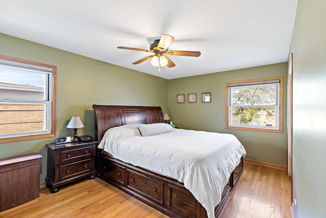 bedroom with ceiling fan, light wood-type flooring, and baseboards