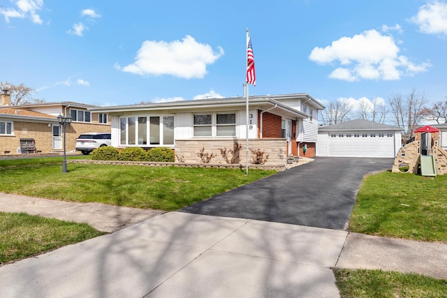 view of front of home featuring an outdoor structure, a detached garage, a front yard, and stone siding