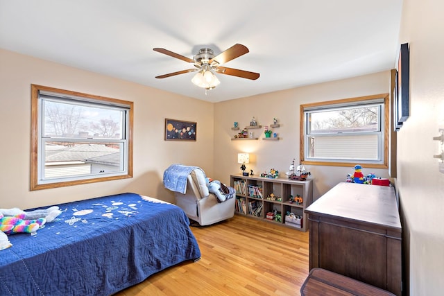 bedroom with light wood-type flooring and a ceiling fan