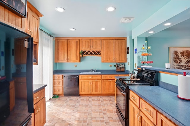kitchen featuring a sink, black appliances, and recessed lighting