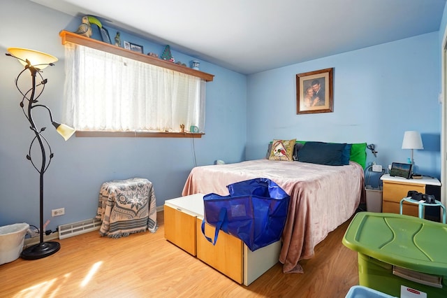 bedroom with visible vents and wood finished floors