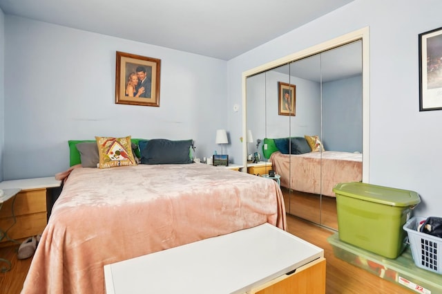 bedroom with a closet and wood finished floors