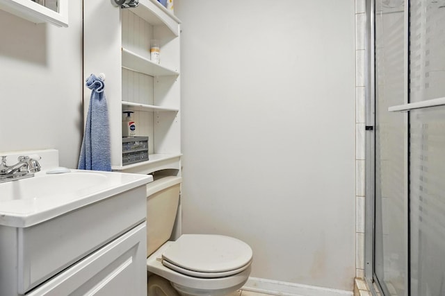 full bathroom featuring vanity, baseboards, a stall shower, and toilet