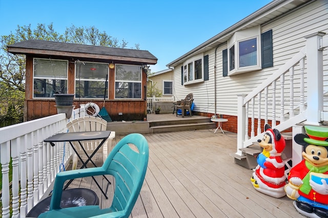 wooden deck featuring a sunroom