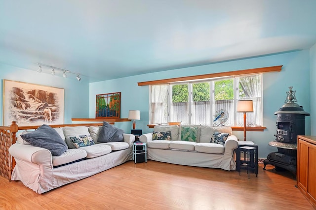 living area with track lighting and wood finished floors