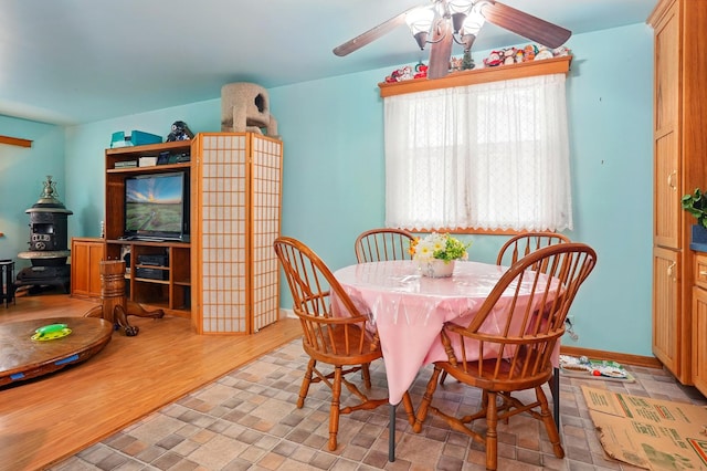 dining space with baseboards and ceiling fan