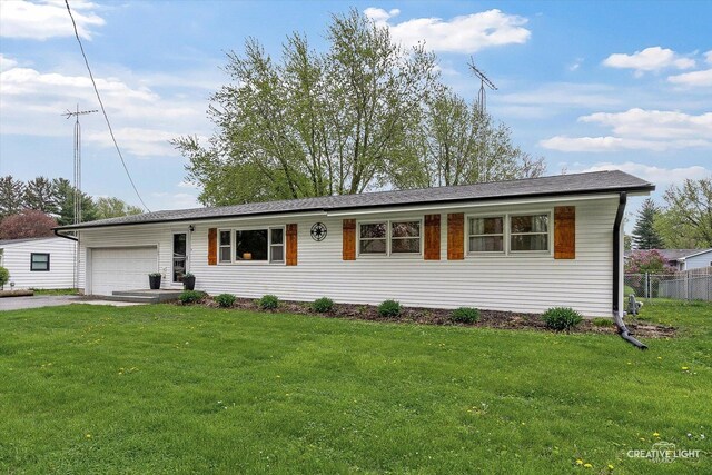 145 W Eisenhower St, Waterman, IL 60556 - ranch-style house featuring a garage, aphalt driveway, fence, and a front yard