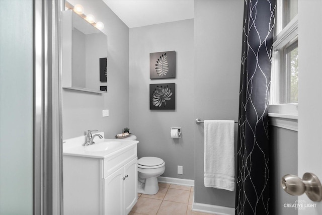 145 W Eisenhower St, Waterman, IL 60556 - bathroom with toilet, tile patterned floors, baseboards, and vanity