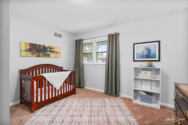 145 W Eisenhower St, Waterman, IL 60556 - bedroom featuring carpet floors, baseboards, a nursery area, and visible vents