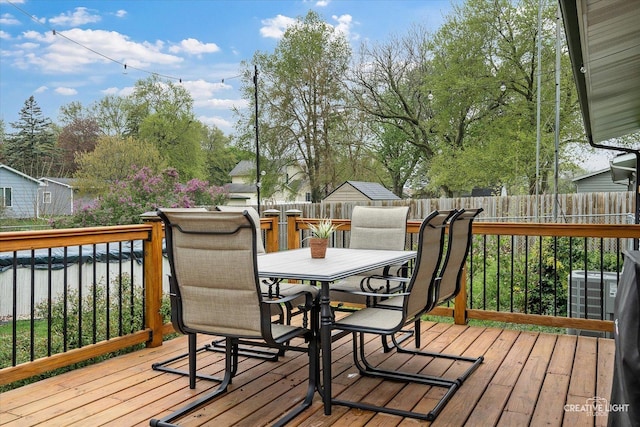 145 W Eisenhower St, Waterman, IL 60556 - deck featuring outdoor dining space and a fenced backyard
