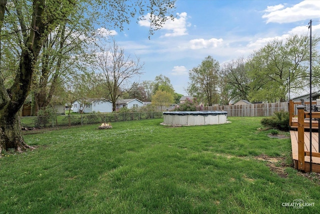 145 W Eisenhower St, Waterman, IL 60556 - view of yard featuring a fenced in pool, a fenced backyard, and a wooden deck