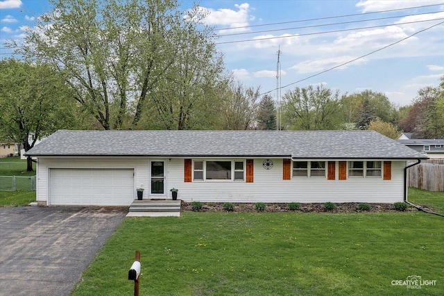 145 W Eisenhower St, Waterman, IL 60556 - single story home with an attached garage, fence, a front yard, and aphalt driveway