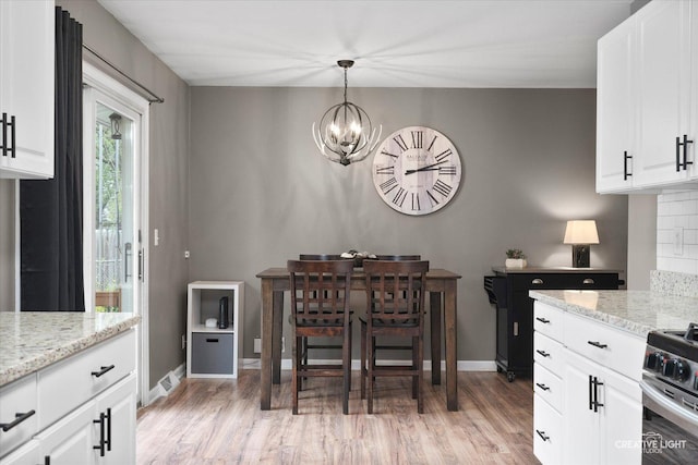 145 W Eisenhower St, Waterman, IL 60556 - dining room featuring baseboards, a chandelier, and light wood-style floors