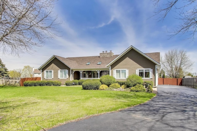 2502 S Hidden Trl, Spring Grove, IL 60081 - single story home featuring a chimney, fence, a shingled roof, aphalt driveway, and a front lawn