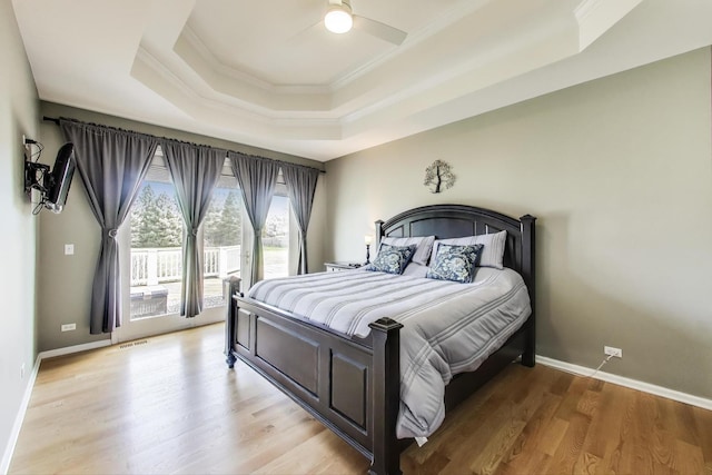 2502 S Hidden Trl, Spring Grove, IL 60081 - bedroom with ornamental molding, visible vents, a raised ceiling, light wood-type flooring, and access to exterior