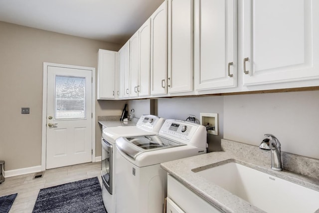 2502 S Hidden Trl, Spring Grove, IL 60081 - laundry room with baseboards, washer and dryer, visible vents, a sink, and cabinet space