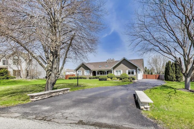 2502 S Hidden Trl, Spring Grove, IL 60081 - single story home with a garage, fence, a chimney, aphalt driveway, and a front yard