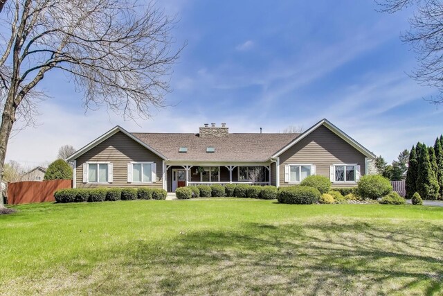 2502 S Hidden Trl, Spring Grove, IL 60081 - view of front facade with a shingled roof, a chimney, fence, and a front yard