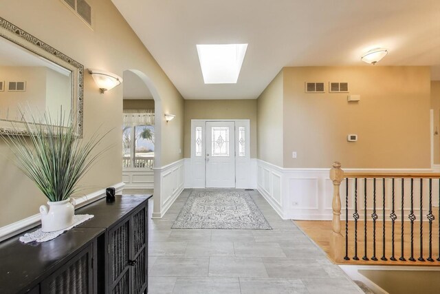 2502 S Hidden Trl, Spring Grove, IL 60081 - doorway to outside featuring a decorative wall, visible vents, and a wainscoted wall