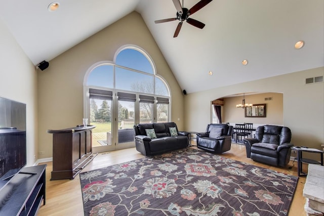 2502 S Hidden Trl, Spring Grove, IL 60081 - living area featuring light wood-type flooring, ceiling fan with notable chandelier, high vaulted ceiling, and visible vents