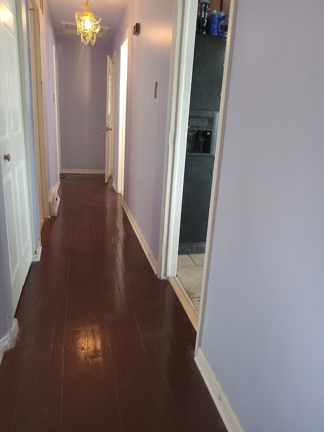 hall with hardwood / wood-style flooring and baseboards