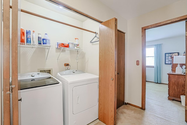 laundry room featuring baseboards, laundry area, light carpet, and washer and clothes dryer