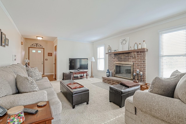 carpeted living area featuring baseboards, ornamental molding, and a brick fireplace