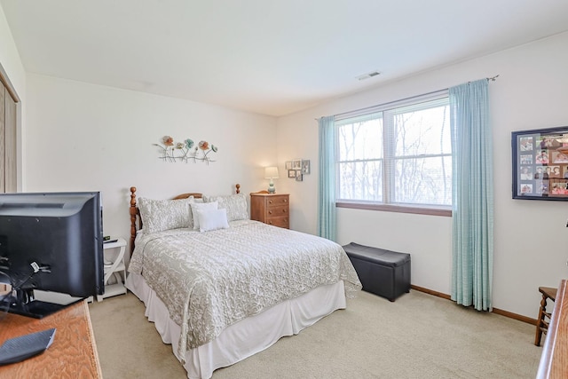 bedroom featuring baseboards, light carpet, and visible vents
