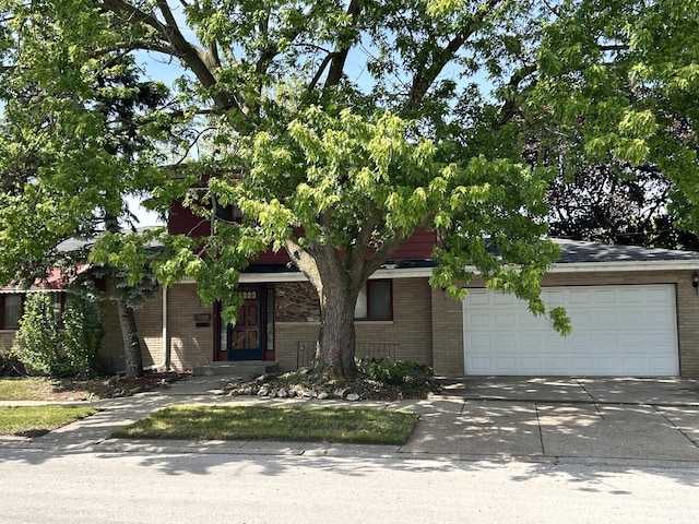 621 Superior Ave, Calumet City, IL 60409 - obstructed view of property featuring brick siding, an attached garage, and concrete driveway