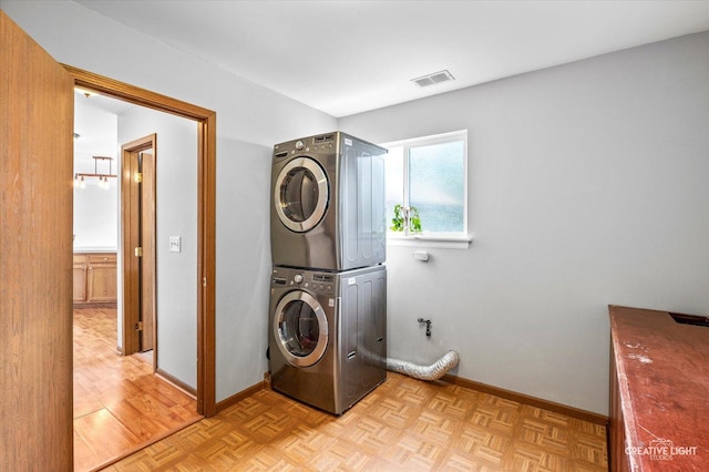 1118 Golden Oaks Pkwy, Aurora, IL 60506 - washroom with stacked washing machine and dryer and baseboards