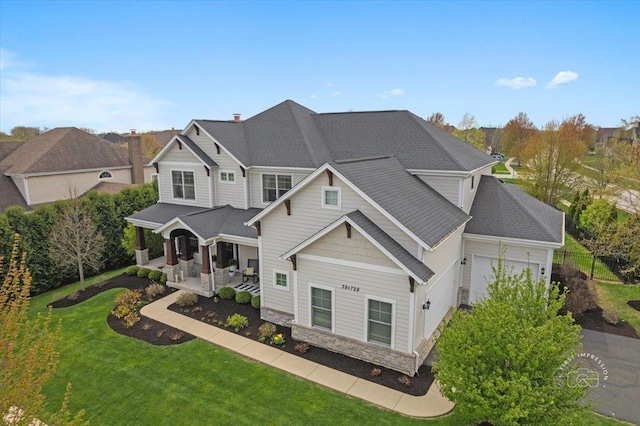 39W729 N Hathaway Ln, Geneva, IL 60134 - view of front facade featuring a garage, a front lawn, fence, and stone siding