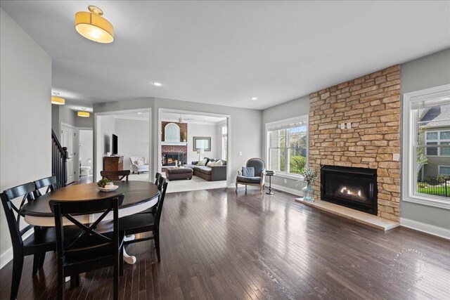 39W729 N Hathaway Ln, Geneva, IL 60134 - dining space with stairway, baseboards, a fireplace, and wood-type flooring