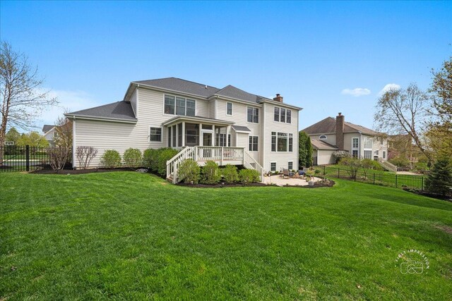 39W729 N Hathaway Ln, Geneva, IL 60134 - back of house featuring a yard, a chimney, a fenced backyard, and a sunroom