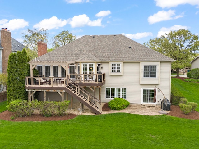 back of property with a pergola, a wooden deck, a lawn, and a patio