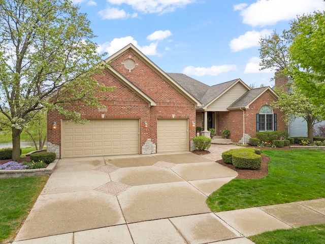 view of front of house featuring brick siding, an attached garage, a front lawn, and concrete driveway