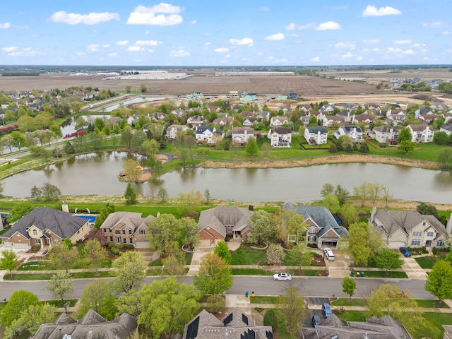 aerial view of residential area featuring a nearby body of water